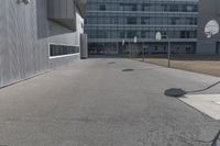 a stop sign sits in the middle of the road outside of an industrial building with glass