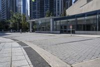 a person sitting at the bench in front of a mall that is empty of people