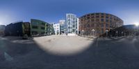 a view through the hole of a street outside of a building area, surrounded by buildings and other architecture