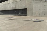 an empty parking garage on a concrete surface with stairs and an iron shuttered door