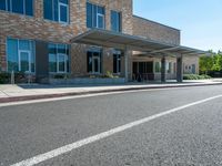 a sidewalk that has a sidewalk sign on it that says green lane park school, in the middle of the street are two buildings with windows and three storys with a sky background