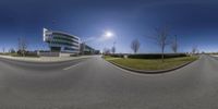 an image of some kind of town at the edge of a street with a big building in the background