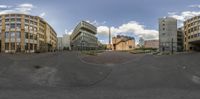 a couple of buildings next to each other in the street in this panorama camera image
