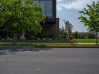 a building with a logo painted on the side near a street that has a sidewalk next to it