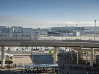 an aerial view of a busy airport with vehicles and motorcycles on the road and people walking on the walkway