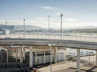 an aerial view of a busy airport with vehicles and motorcycles on the road and people walking on the walkway