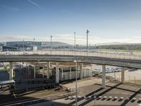 an aerial view of a busy airport with vehicles and motorcycles on the road and people walking on the walkway