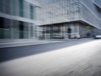 the photo is blurry and shows a street full of people and cars passing by