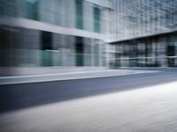 the photo is blurry and shows a street full of people and cars passing by