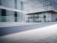 the photo is blurry and shows a street full of people and cars passing by