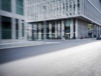 the photo is blurry and shows a street full of people and cars passing by