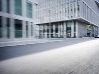 the photo is blurry and shows a street full of people and cars passing by