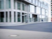 the photo is blurry and shows a street full of people and cars passing by