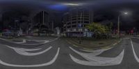 a 360 - angle lens shows traffic passing through a city intersection and buildings as well as dark clouds