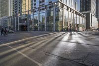 a busy city street with glass buildings in the background and a red light on the corner