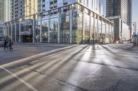 a busy city street with glass buildings in the background and a red light on the corner