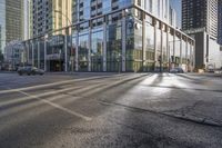 a busy city street with glass buildings in the background and a red light on the corner