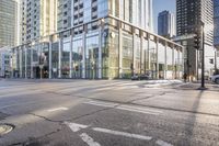 a busy city street with glass buildings in the background and a red light on the corner