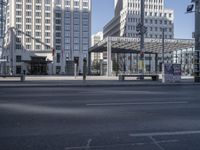 a street filled with traffic lights and tall buildings in a city setting with a person crossing the road in front of the building