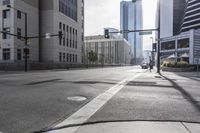 an empty city street filled with lots of traffic, and tall buildings in the background