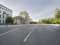 an empty street in europe during the day with lots of traffic on both sides of it