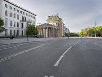 an empty street in europe during the day with lots of traffic on both sides of it