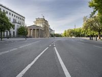 an empty street in europe during the day with lots of traffic on both sides of it