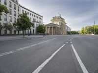 an empty street in europe during the day with lots of traffic on both sides of it