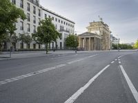 an empty street in europe during the day with lots of traffic on both sides of it