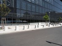 a building that is next to some benches in the street while someone is walking by