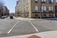 a couple of cars driving down a street next to buildings and a staircase way on either side of it