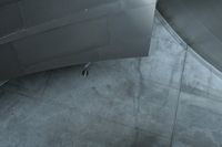 an aerial view of a man walking down stairs next to a building, surrounded by stairs