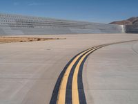 an airplane that is parked at the airport runway with two yellow lines going down the side