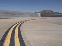 an airplane that is parked at the airport runway with two yellow lines going down the side