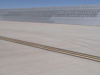 an airplane that is on a runway by itself in the air and a yellow line running down the aisle