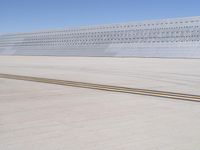 an airplane that is on a runway by itself in the air and a yellow line running down the aisle