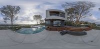 a 360 - angle view of the house from across the pool area, while looking out