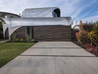 a house is clad with the distinctive form of waves on the exterior wall of the home