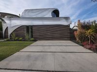 a house is clad with the distinctive form of waves on the exterior wall of the home