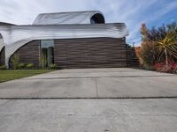 a house is clad with the distinctive form of waves on the exterior wall of the home