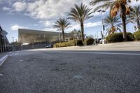 the large building is in the background with palm trees outside it and parking lot next to it