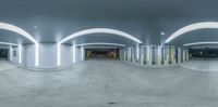 an empty parking garage with skateboarders and ramps near by the stairs and onlookers