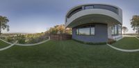 an abstract image of the outside of a modern home on a sunny day with grass surrounding