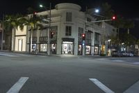 a city street with stores and palm trees at night time in miami beach, florida