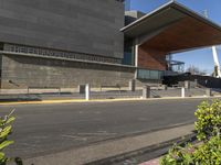 a view of a building with stone and glass on the front and the entrance and stairs