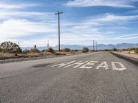 Asphalt Road Cutting Through California Desert