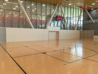 a tennis court with the net sticking out on the floor at the end of it