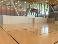 a tennis court with the net sticking out on the floor at the end of it