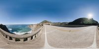 a view of the sea from the bridge in a 360 - vr experience image of a section of highway with cars driving on it