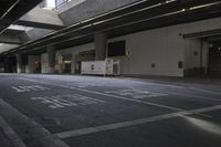 a empty street with parking lots at night, and empty space between two walkways